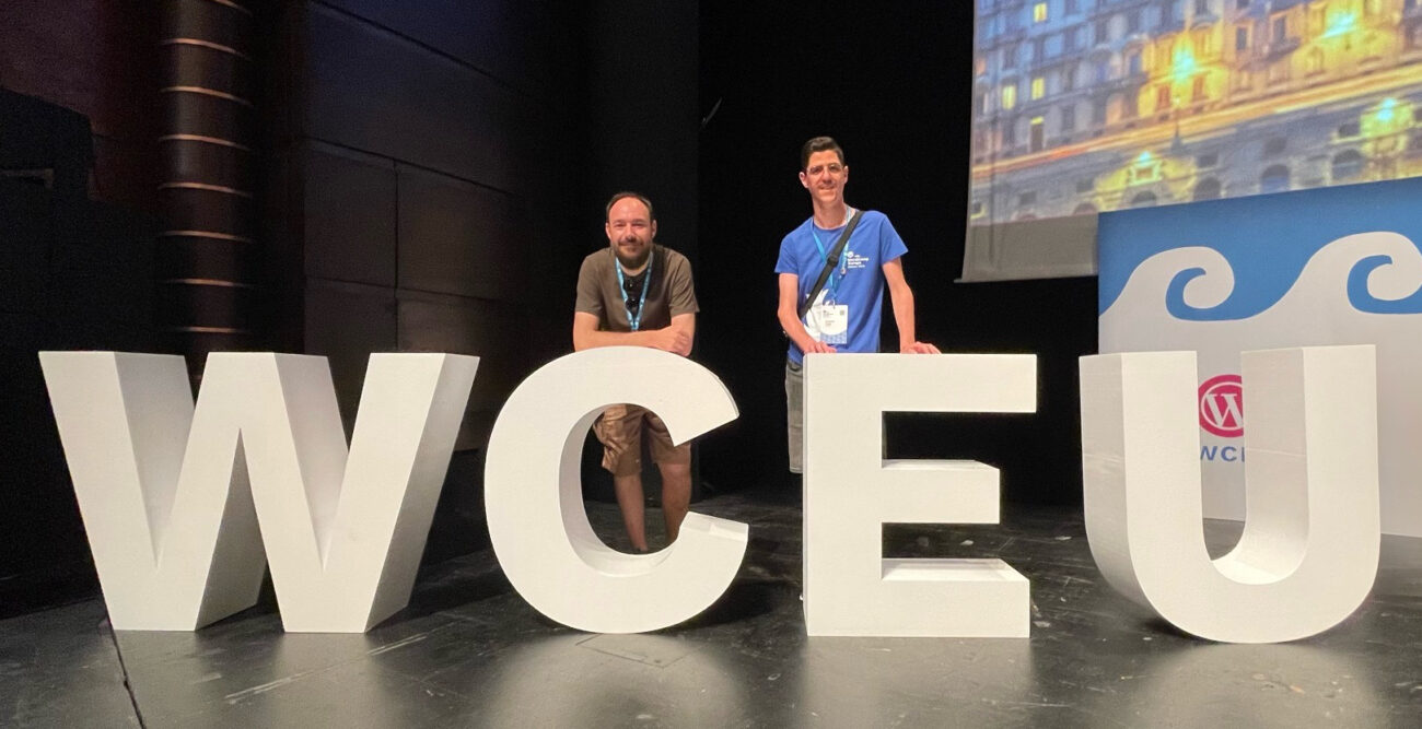 Francisco and Roberto, members of GIGA4, posing next to the WCEU letters at WordCamp Europe 2023.